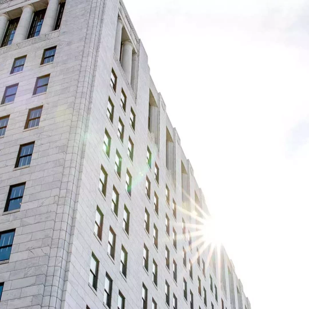 Photo of sun reflecting off  stone building 